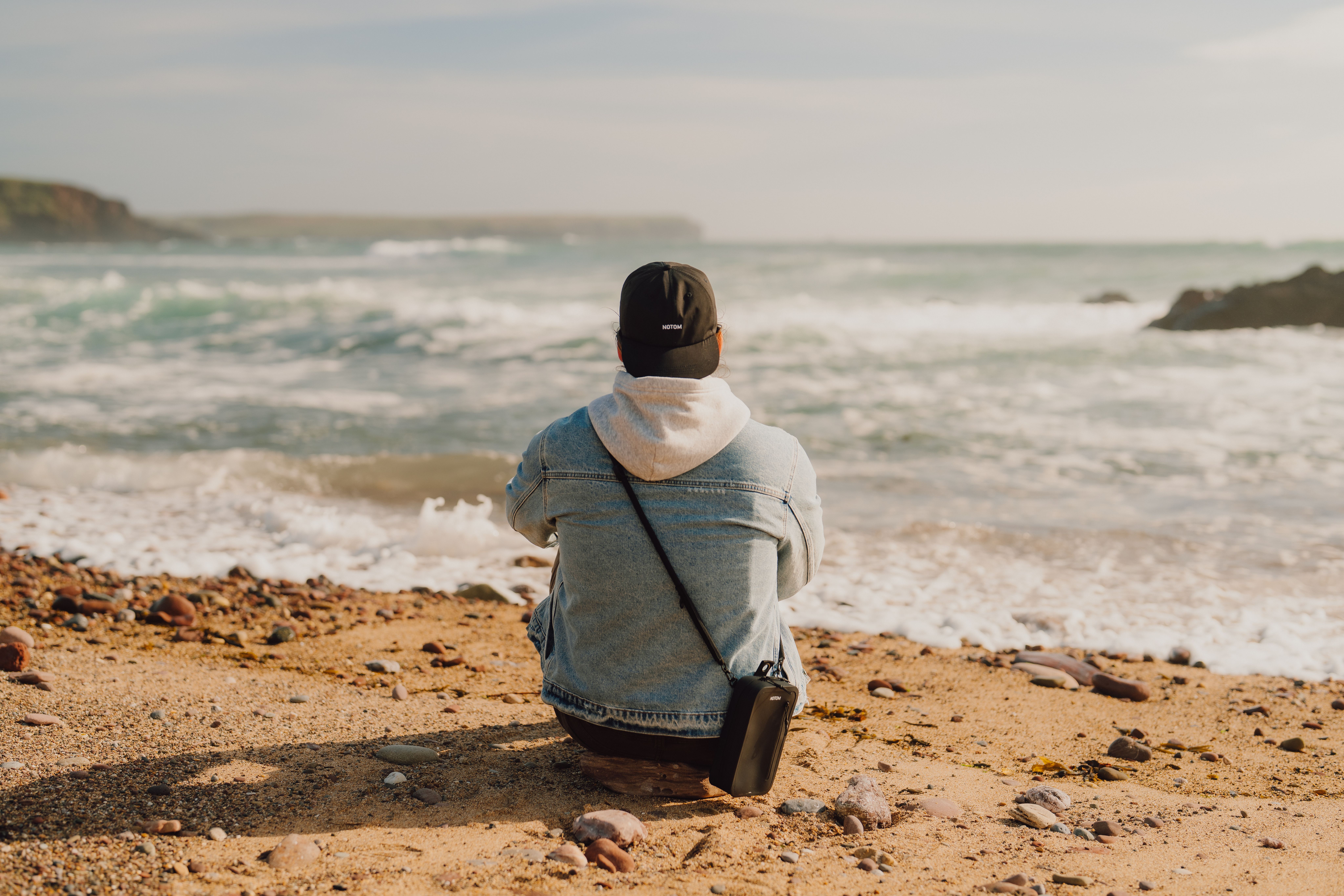 Prepared with NOTOM Sling Bag on the beach overlooking the ocean